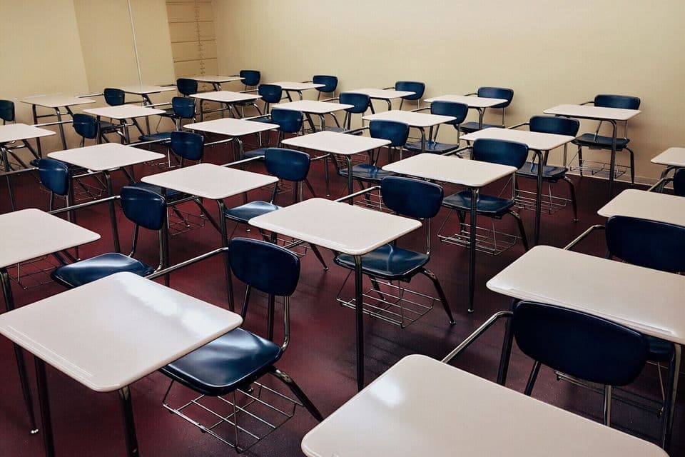 A classroom with desks and chairs